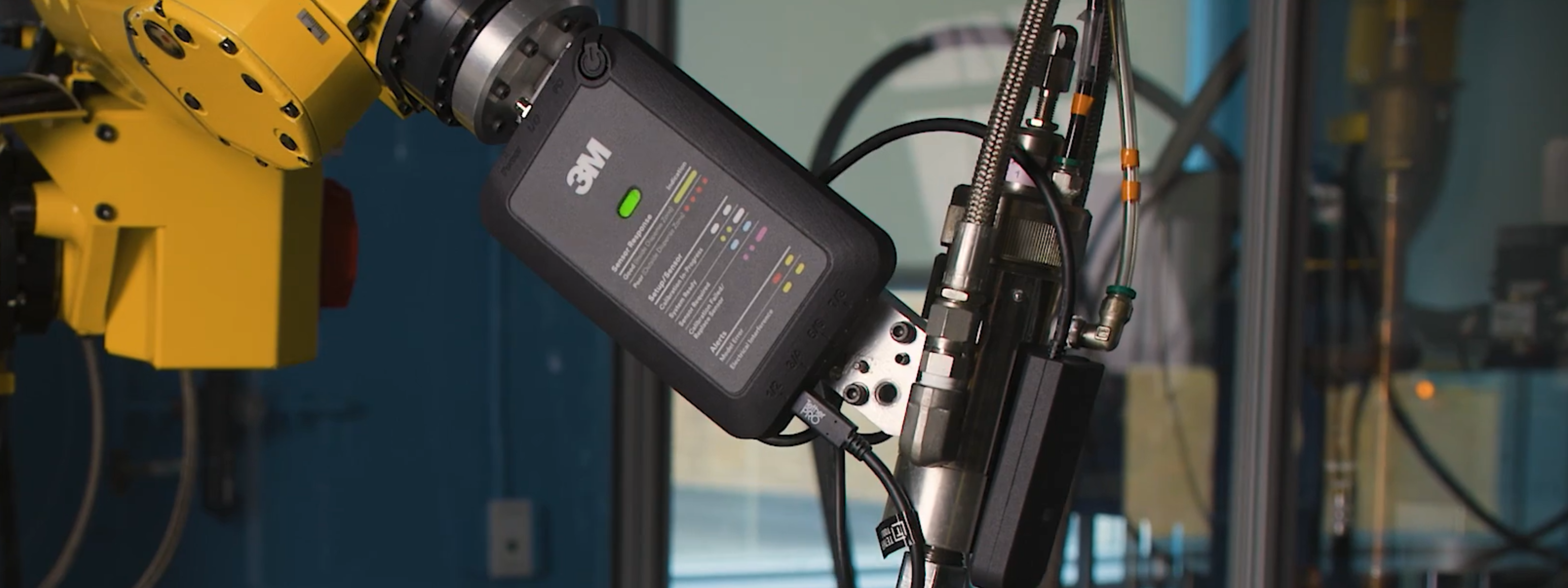 3M Adhesive Mix Monitor system with in-line sensor, amplifier/reader, and processing unit integrated into a two-part adhesive dispensing setup